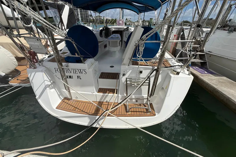 Slide: The Image of 2009 Beneteau Oceanis 40 docked, showcasing rear deck and seating area. - 88