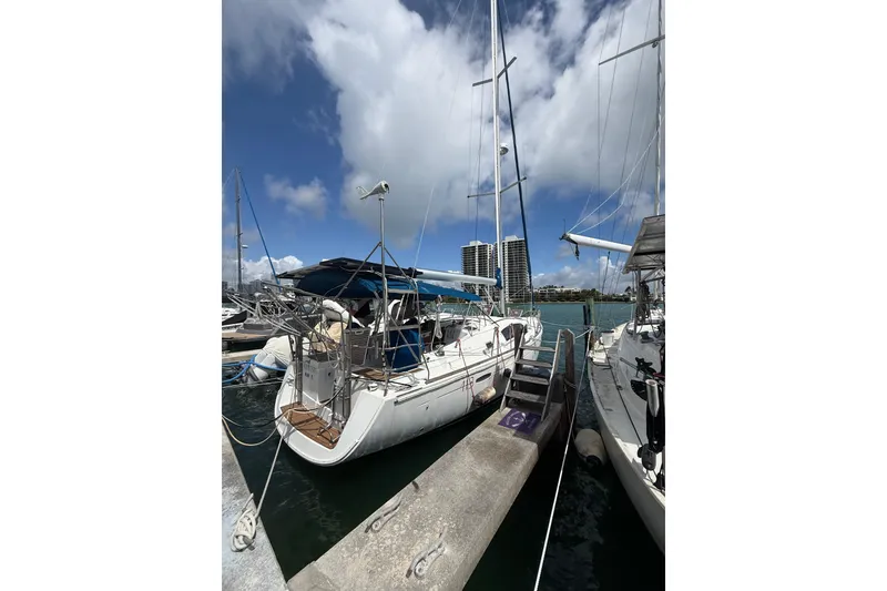 Slide: The Image of 2009 Beneteau Oceanis 40 sailboat docked at marina under blue sky. - 89