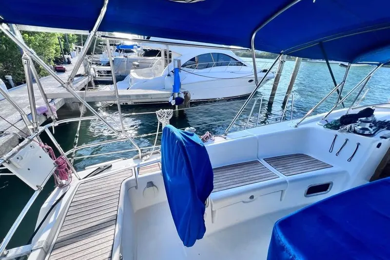 Slide: The Image of Beneteau Oceanis 40 sailboat cockpit, 2009 model, docked at marina with blue canopy. - 9