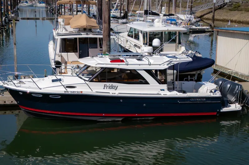 The Image of 2019 Cutwater C-302 Coupe docked in a marina, featuring sleek design and modern amenities. - 0