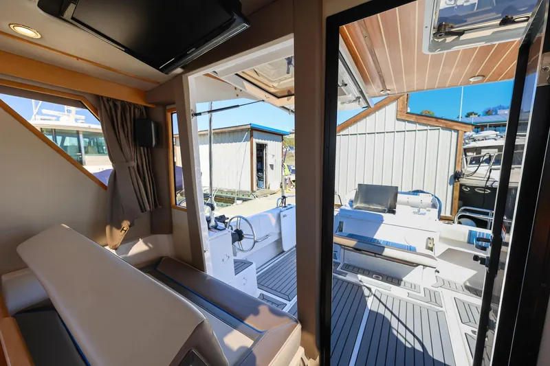 Slide: The Image of Interior view of 2019 Cutwater C-302 Coupe boat, showcasing seating and helm area. - 11