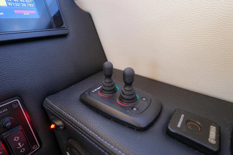 Slide: The Image of Control panel of a 2019 Cutwater C-302 Coupe boat with joysticks and display. - 14