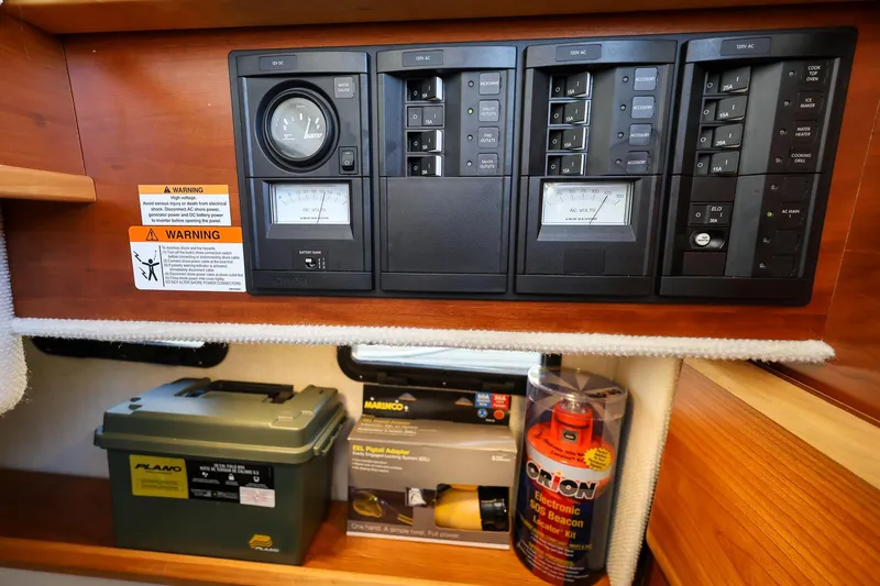 Slide: The Image of Electrical panel and safety equipment inside a 2019 Cutwater C-302 Coupe boat. - 31