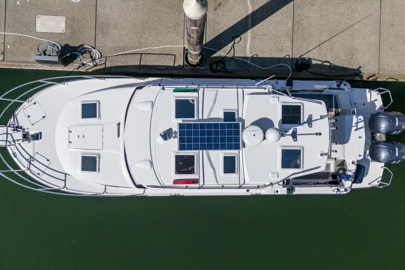 Slide: The Image of Overhead view of a 2019 Cutwater C-302 Coupe boat docked, featuring solar panels. - 35