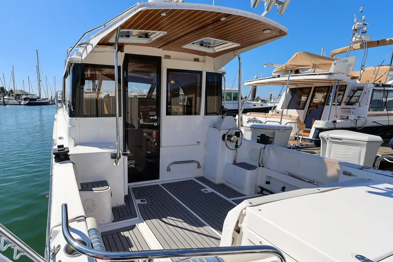 Slide: The Image of 2019 Cutwater C-302 Coupe docked at marina, showcasing spacious deck and sleek design. - 4