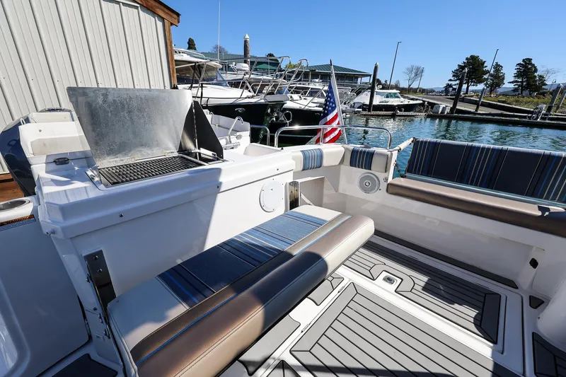 Slide: The Image of 2019 Cutwater C-302 Coupe boat with seating and grill at marina. - 7