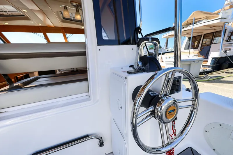 Slide: The Image of 2019 Cutwater C-302 Coupe helm with steering wheel and interior seating. - 9