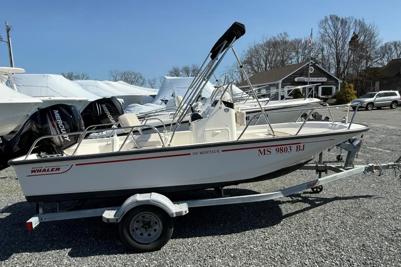 The Image of 2018 Boston Whaler 150 Montauk boat on trailer in outdoor lot. - 0