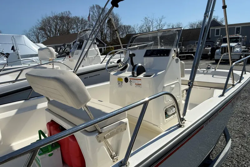 Slide: The Image of 2018 Boston Whaler 150 Montauk boat interior with steering console and seating. - 5