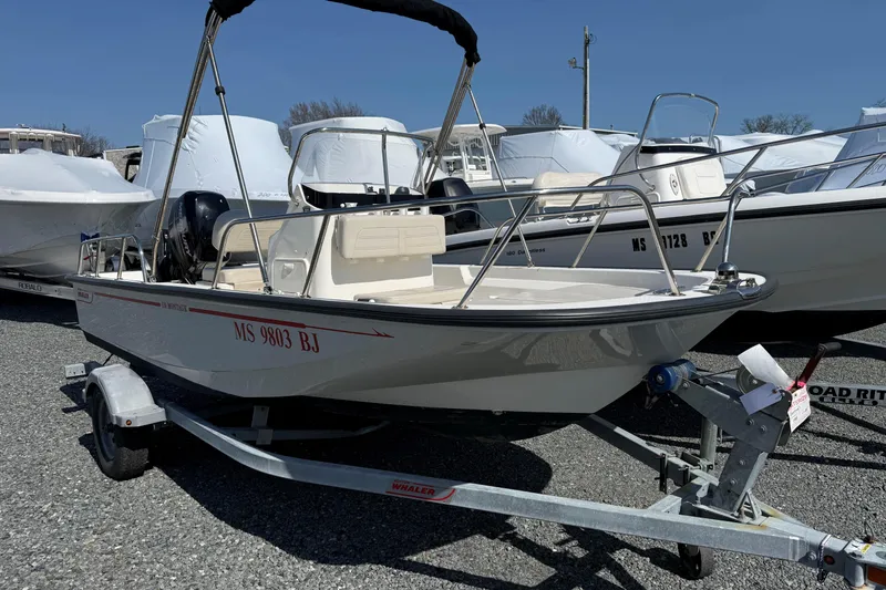 Slide: The Image of 2018 Boston Whaler 150 Montauk boat on trailer, parked outdoors. - 7