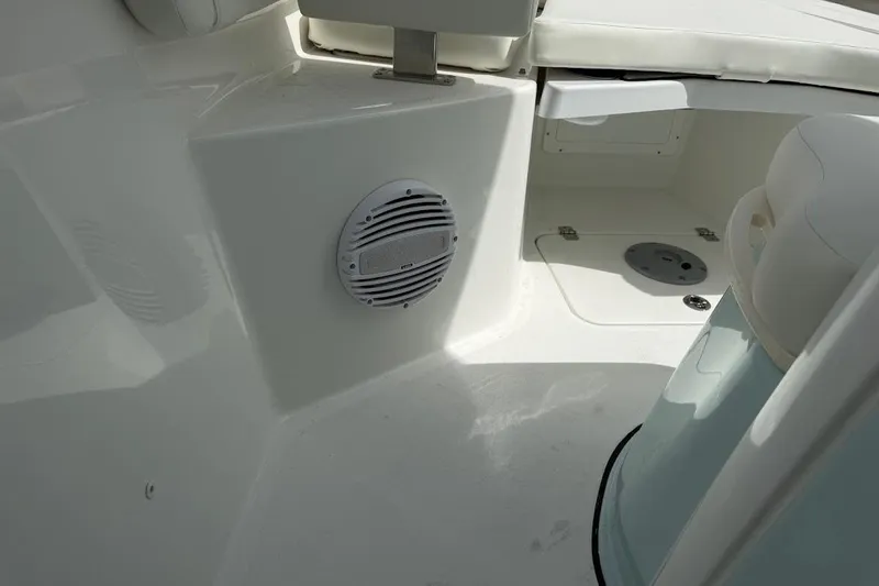 Slide: The Image of Interior view of 2026 Sea Pro 265FLX Sandbar boat, featuring seating and speaker. - 13