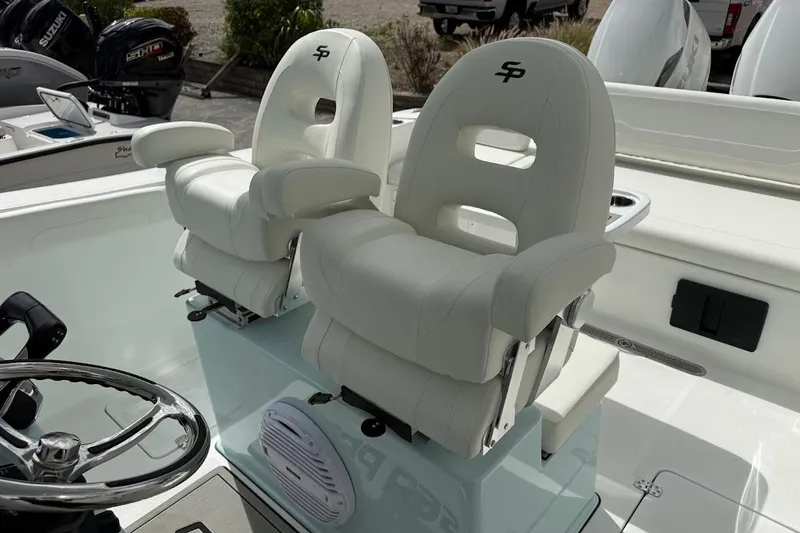 Slide: The Image of 2026 Sea Pro 265FLX Sandbar boat with luxurious white seating and steering wheel. - 14