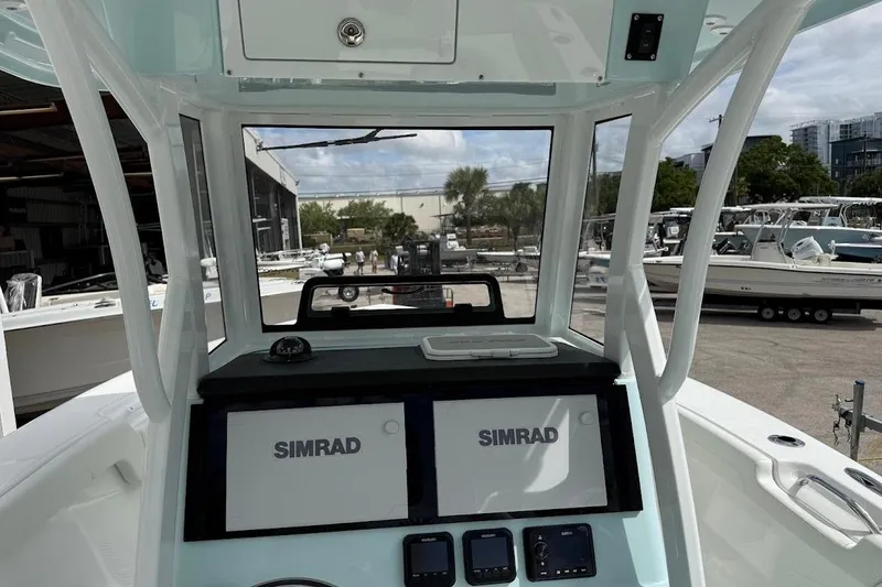 Slide: The Image of 2026 Sea Pro 265FLX Sandbar boat dashboard with dual Simrad displays. - 16