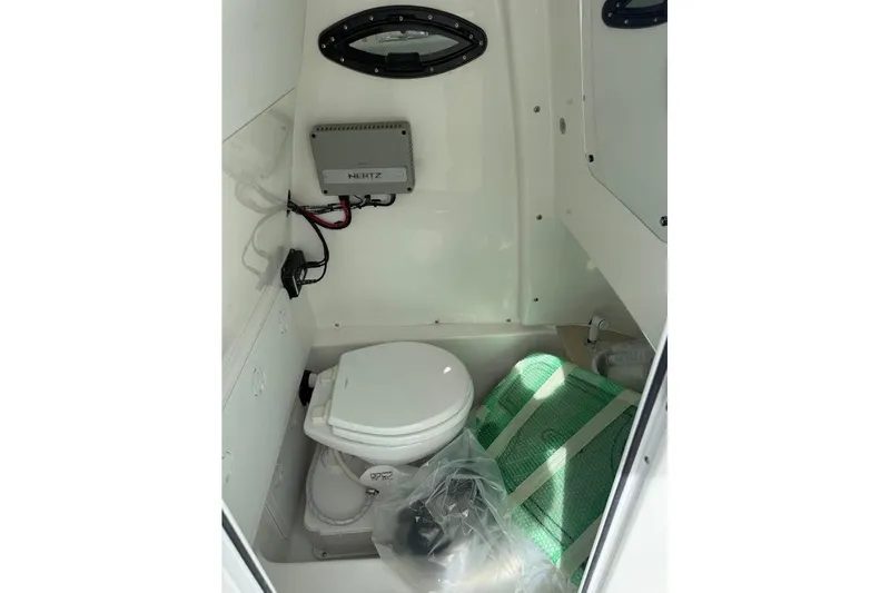 Slide: The Image of Interior of 2026 Sea Pro 265FLX Sandbar boat with compact marine toilet. - 17