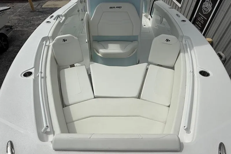 Slide: The Image of 2026 Sea Pro 265FLX Sandbar boat with white cushioned seating and sleek design. - 24
