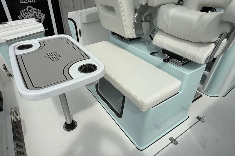 Slide: The Image of 2026 Sea Pro 265FLX Sandbar boat interior with seating and table setup. - 28