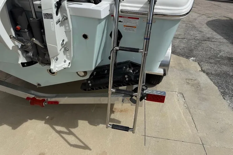 Slide: The Image of Rear view of 2026 Sea Pro 265FLX Sandbar boat with ladder and motor details. - 5