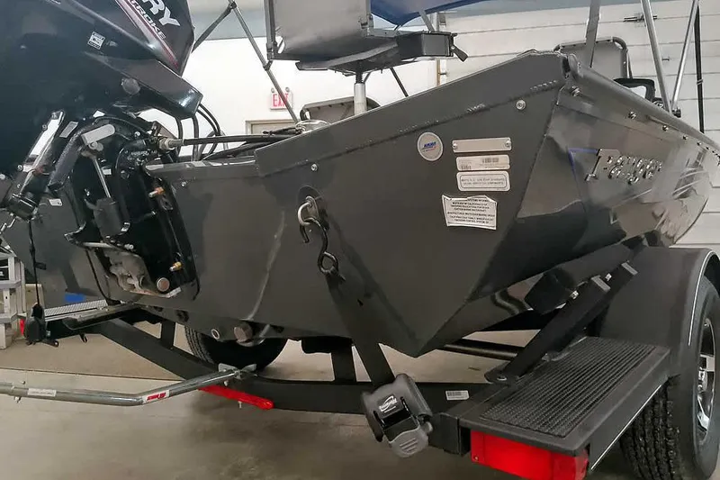 Slide: The Image of 2021 Ranger RT178 boat on trailer, featuring a Mercury outboard motor in a garage setting. - 14