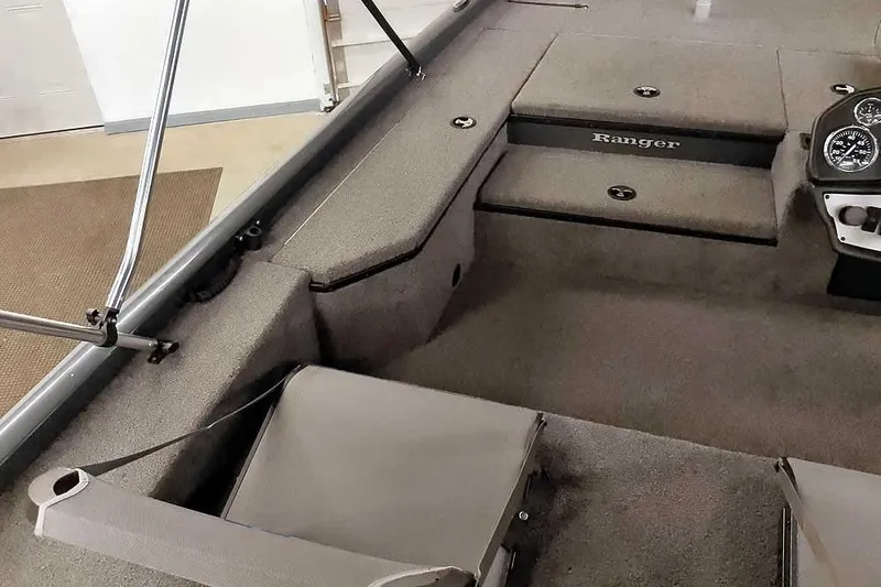Slide: The Image of 2021 Ranger RT178 boat interior with carpeted deck and storage compartments. - 23