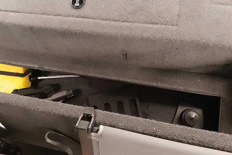 Slide: The Image of Storage compartment of a 2021 Ranger RT178 boat, featuring organized equipment and tools. - 24