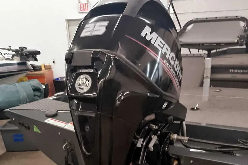 Slide: The Image of 2021 Ranger RT178 boat with Mercury 25 horsepower engine in a garage setting. - 3