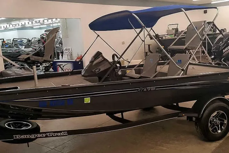 Slide: The Image of 2021 Ranger RT178 boat with blue canopy in showroom. - 34