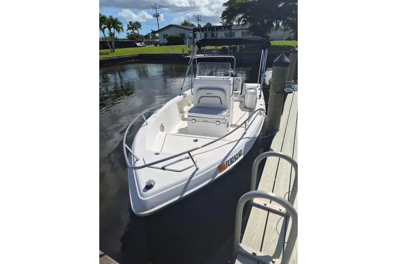The Image of 2006 Sea Fox 197 Center Console boat docked by a serene waterfront. - 0