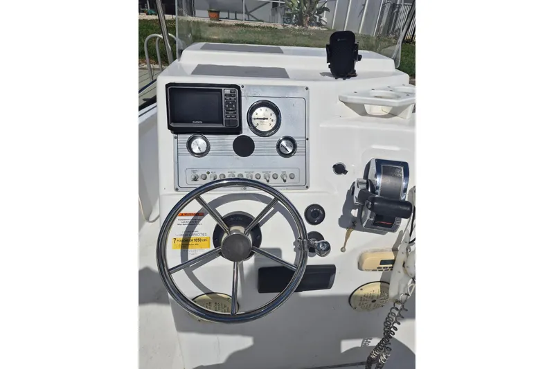Slide: The Image of 2006 Sea Fox 197 Center Console boat dashboard with steering wheel and navigation instruments. - 1