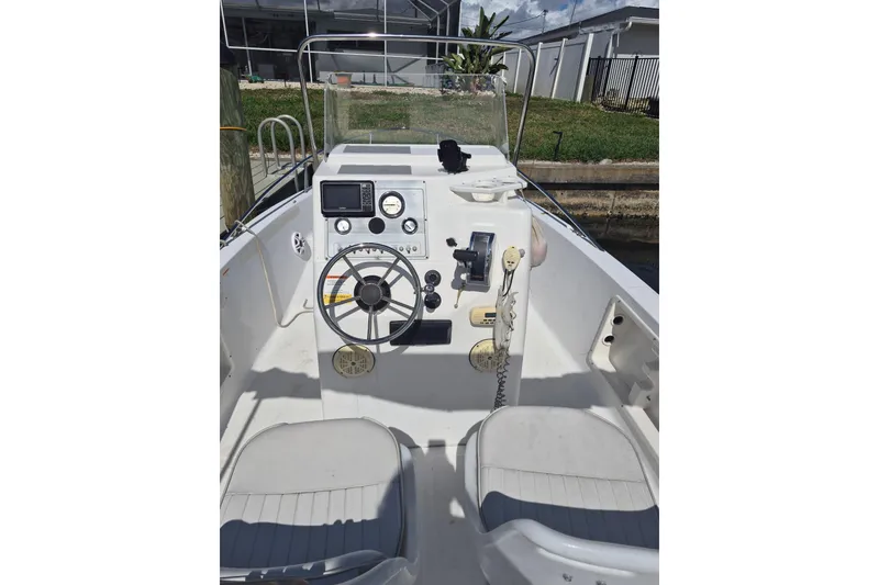 Slide: The Image of 2006 Sea Fox 197 Center Console boat interior with steering wheel and control panel. - 2