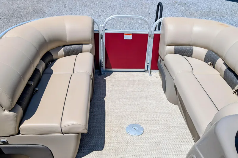 Slide: The Image of Interior of a 2020 Sun Tracker pontoon boat with beige seating and red paneling. - 6