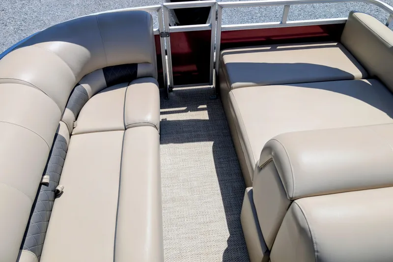 Slide: The Image of 2020 Sun Tracker boat interior with beige cushioned seating and carpeted floor. - 7