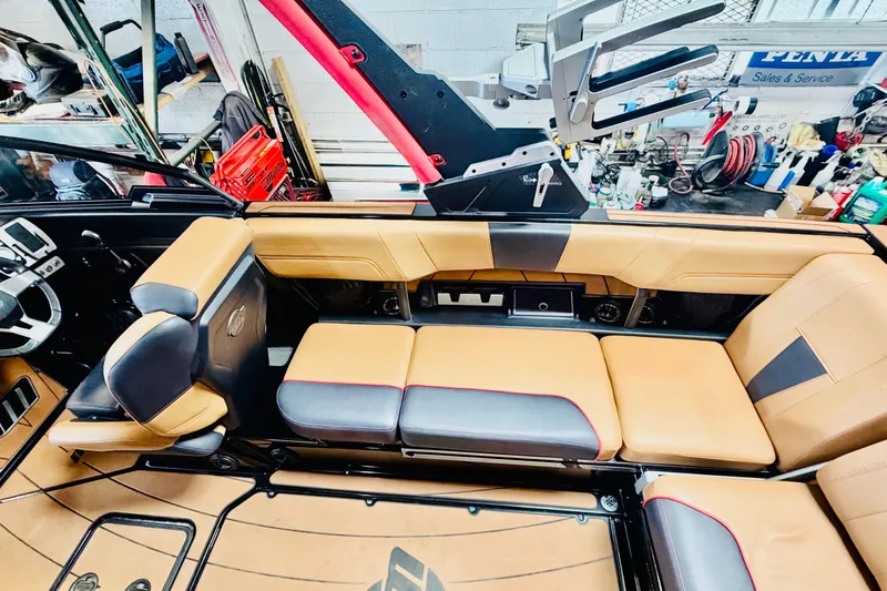 Slide: The Image of 2023 Malibu Wakesetter 23 LSV interior with tan and black seating, showcasing luxury design. - 13
