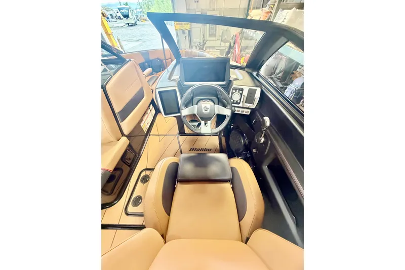 Slide: The Image of 2023 Malibu Wakesetter 23 LSV interior with modern dashboard and steering wheel. - 17