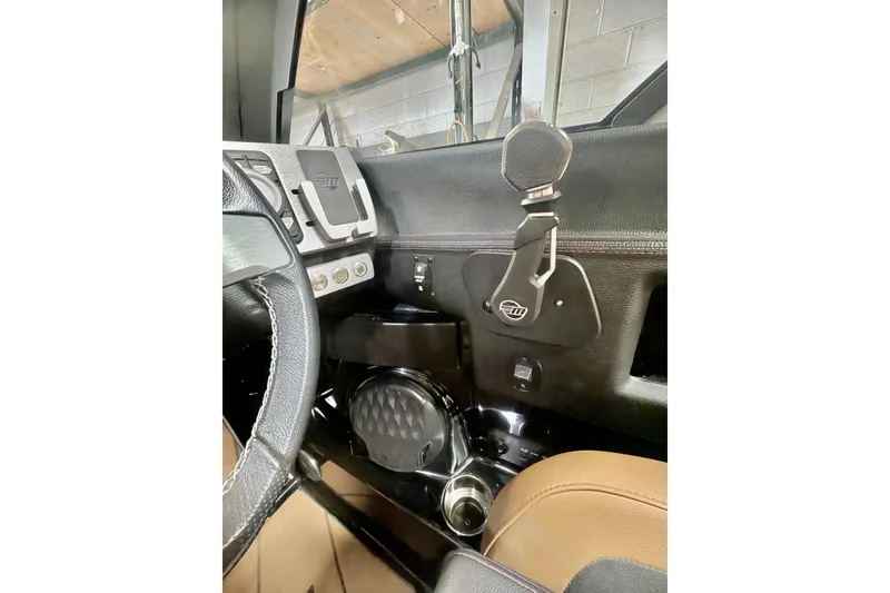 Slide: The Image of Interior view of 2023 Malibu Wakesetter 23 LSV boat dashboard and steering area. - 18