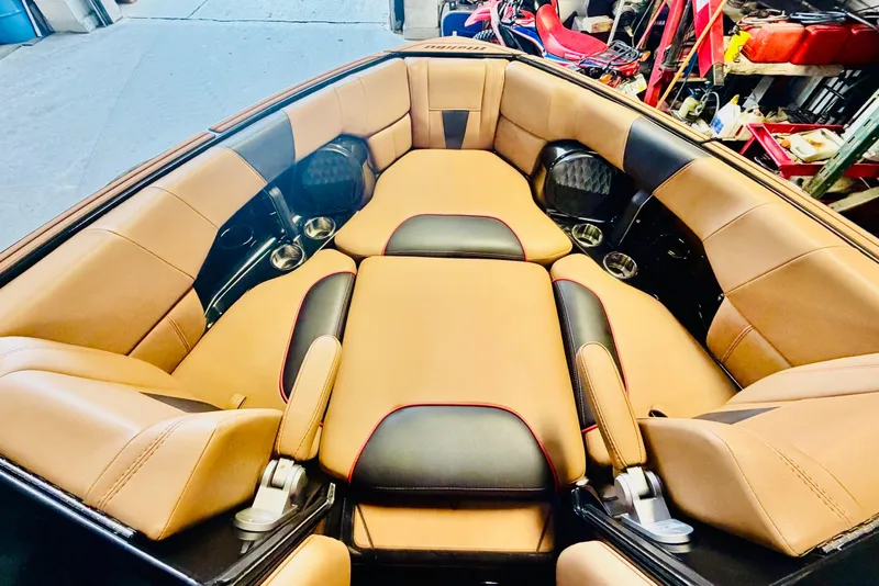 Slide: The Image of Luxurious interior of 2023 Malibu Wakesetter 23 LSV boat with tan and black seating. - 21