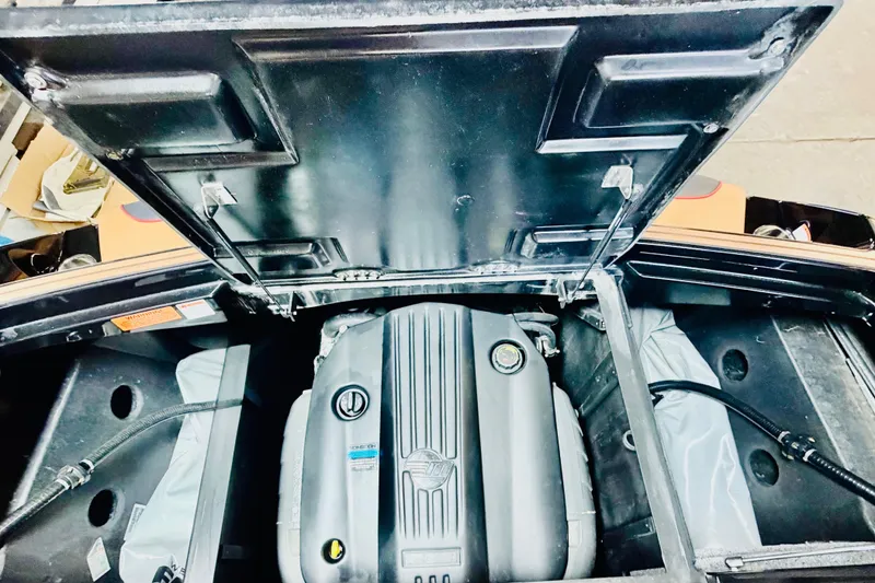 Slide: The Image of Engine compartment of 2023 Malibu Wakesetter 23 LSV boat, showcasing engine details. - 23