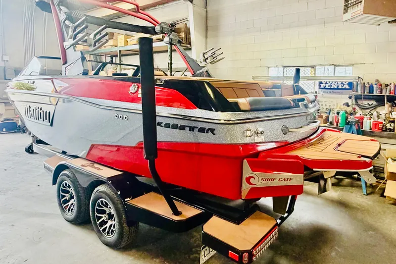 Slide: The Image of 2023 Malibu Wakesetter 23 LSV boat in a garage, showcasing sleek design and vibrant colors. - 3