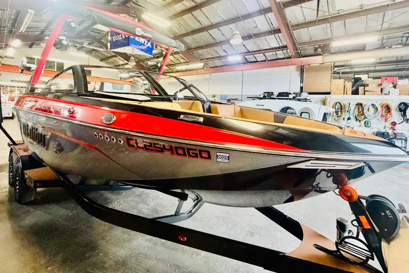 Slide: The Image of 2023 Malibu Wakesetter 23 LSV boat in a showroom, featuring sleek design and vibrant colors. - 5