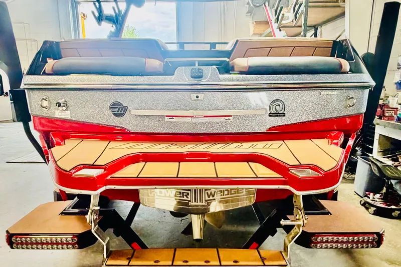 Slide: The Image of 2023 Malibu Wakesetter 23 LSV boat rear view in a garage setting. - 6