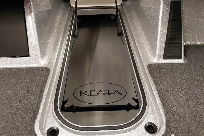 Slide: The Image of 2024 Ranger 1850MS Reata boat interior storage compartment with Reata logo. - 12