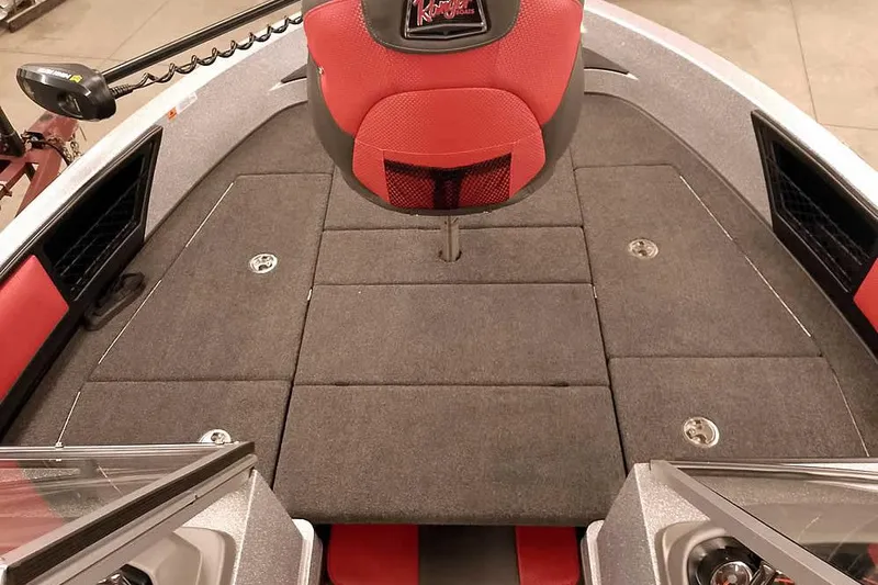 Slide: The Image of 2024 Ranger 1850MS Reata boat interior with red and gray seating and carpeted deck. - 14