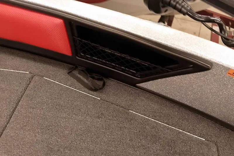 Slide: The Image of 2024 Ranger 1850MS Reata boat interior with red accents and storage compartment. - 21