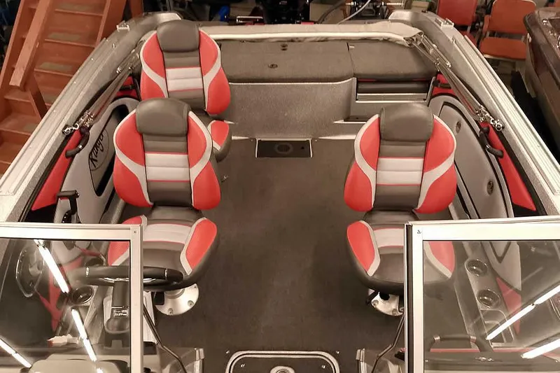 Slide: The Image of 2024 Ranger 1850MS Reata boat interior with red and gray seating, spacious layout. - 22