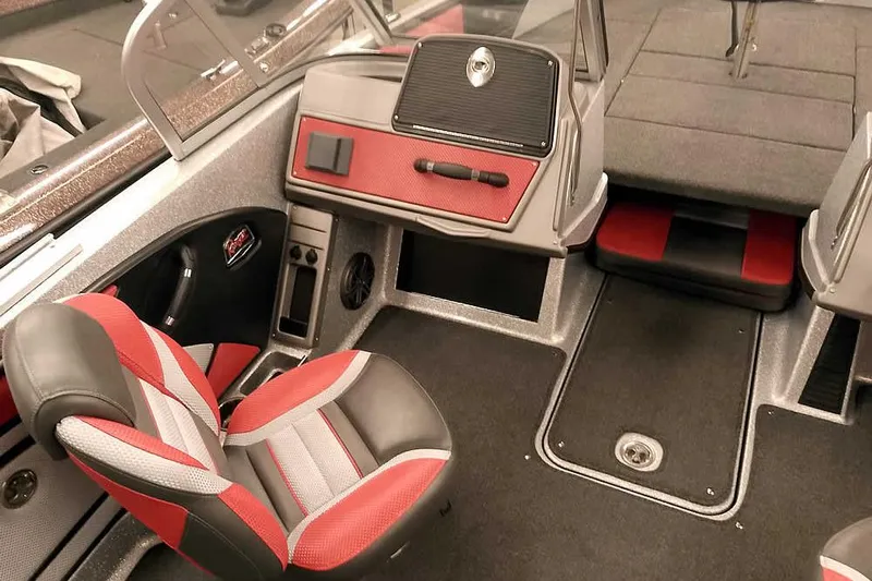 Slide: The Image of 2024 Ranger 1850MS Reata boat interior with red and gray seating and dashboard. - 23