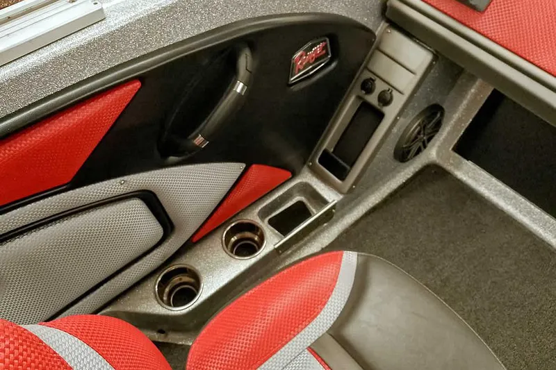 Slide: The Image of 2024 Ranger 1850MS Reata interior with red and gray seating, cup holders, and storage compartments. - 24