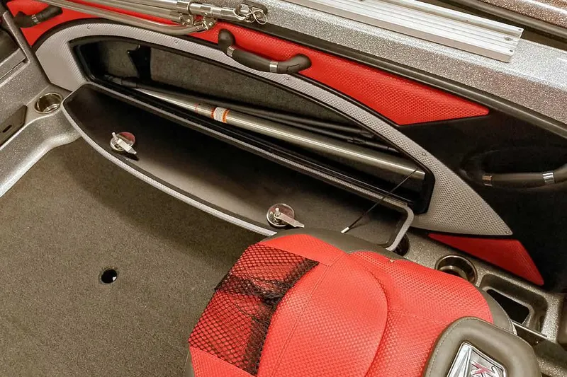 Slide: The Image of 2024 Ranger 1850MS Reata boat interior with rod storage and red seating. - 25