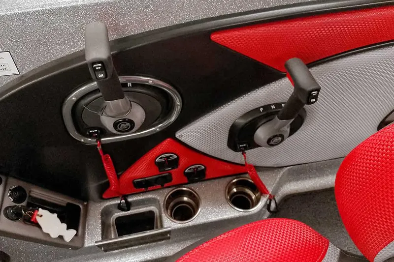 Slide: The Image of 2024 Ranger 1850MS Reata boat controls with red and gray accents, featuring dual levers and cup holders. - 31