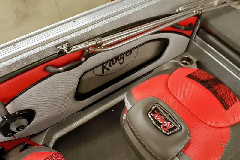 Slide: The Image of 2024 Ranger 1850MS Reata boat interior with red seating and rod storage. - 33
