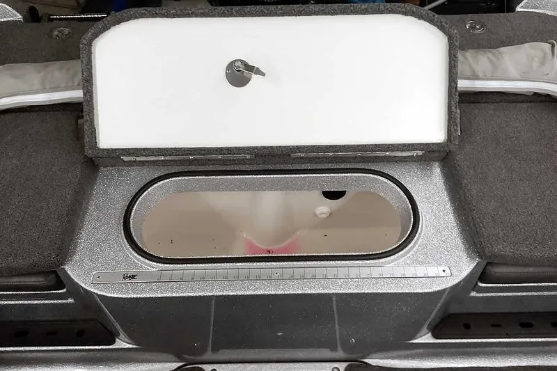 Slide: The Image of 2024 Ranger 1850MS Reata boat interior with storage compartment and measuring ruler. - 34