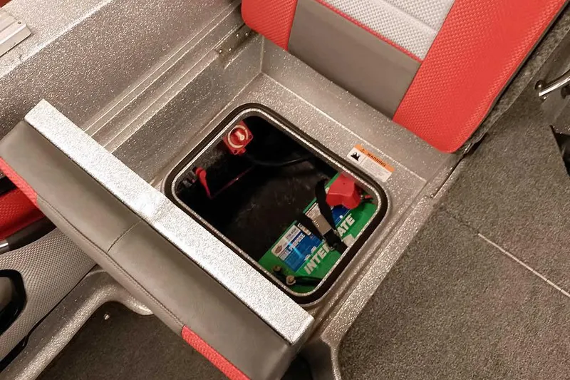 Slide: The Image of 2024 Ranger 1850MS Reata boat battery compartment with red and gray seating. - 39